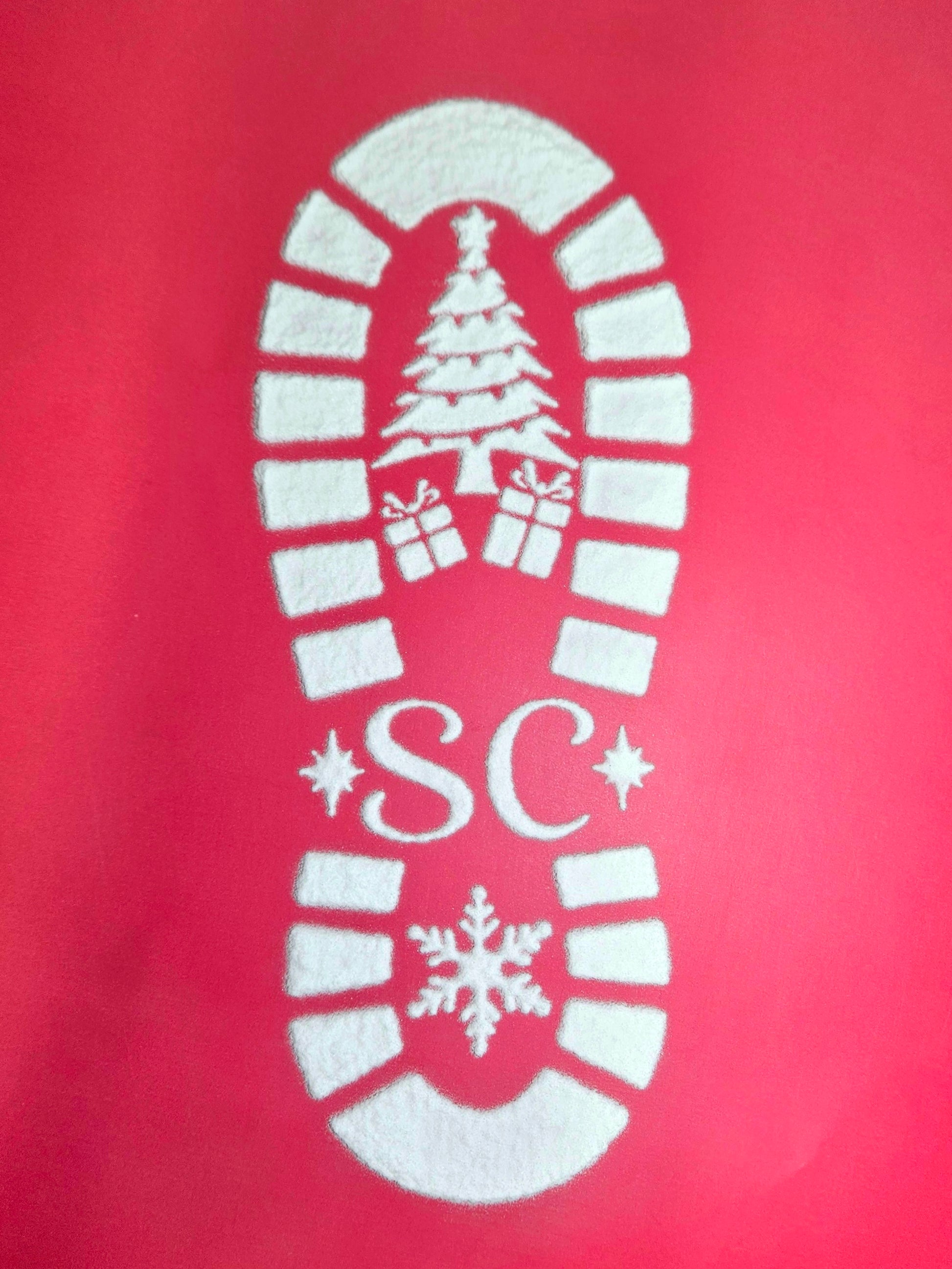 White powder santa footprint on red background