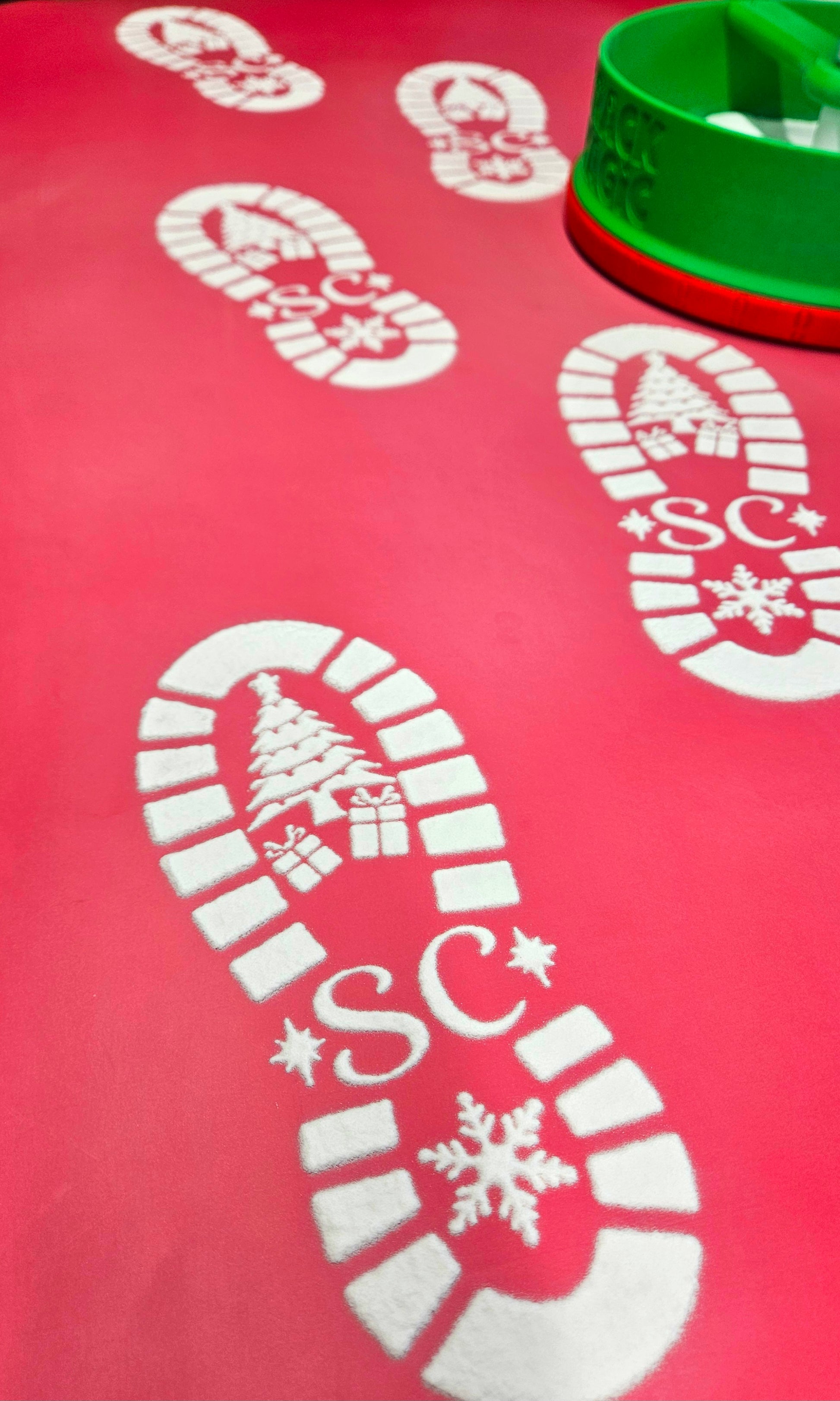 Red mat with white candy cane and snowflake designs on a red background