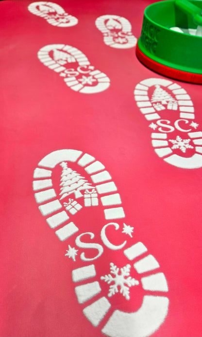 Red mat with white candy cane and snowflake designs on a red background